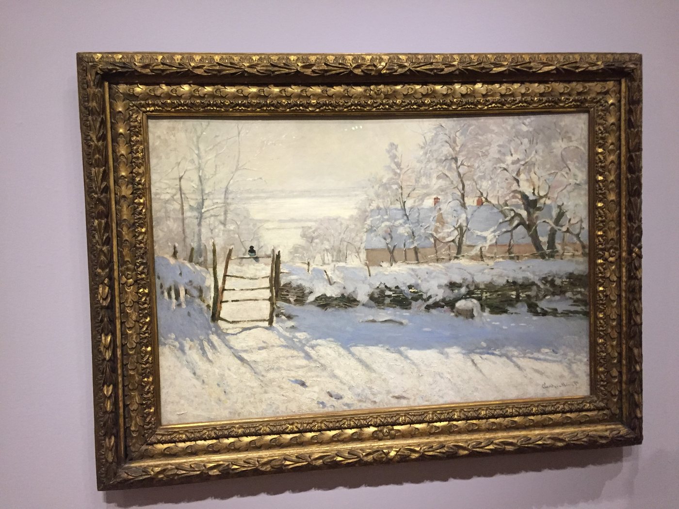 A painting of a snowy field and fence in a gold frame