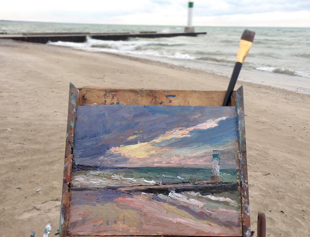 The day’s panel on the easel in front of the Grand Bend pier and lighthouse