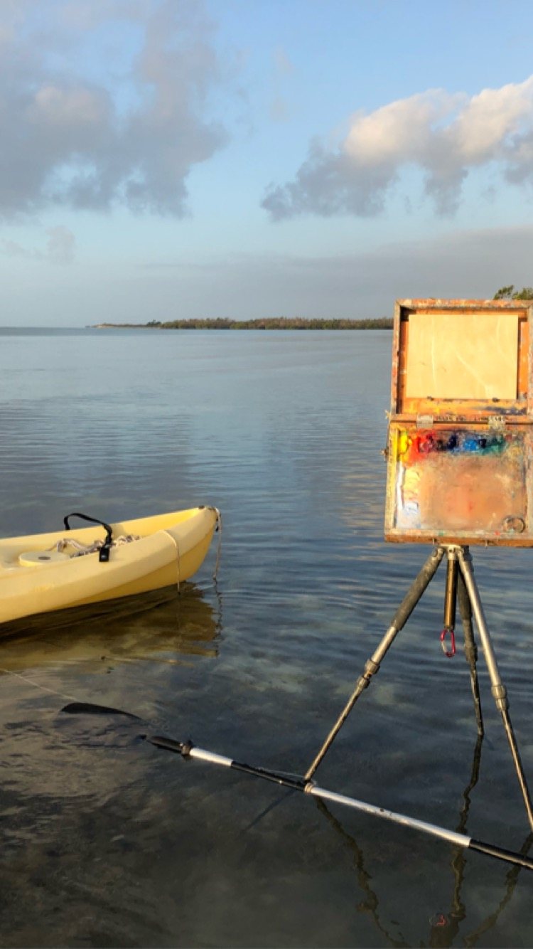 The box on a tripod standing in shallow water in the Florida Keys, a kayak beside it