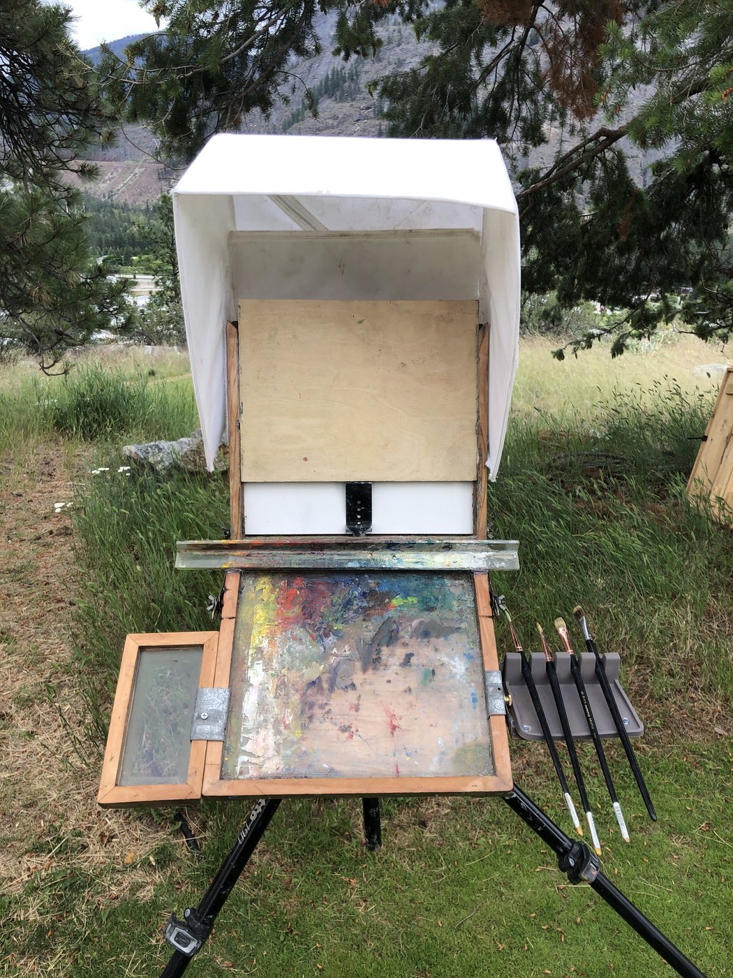 The box with a white makeshift rain cover over the lid