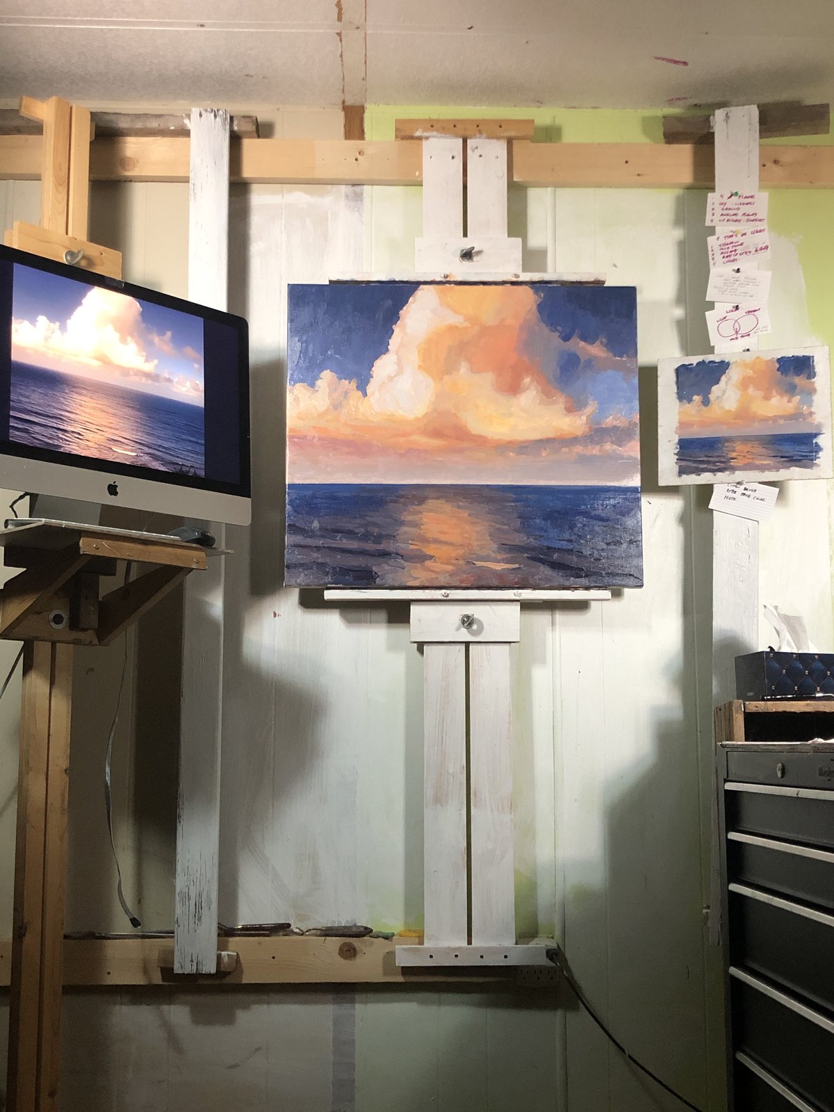 The same studio easel with the larger cloud painting under way