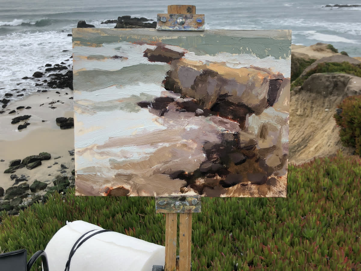 Pescadero Rocks on the easel, outdoors, in front of the place it shows, Pescadero, California
