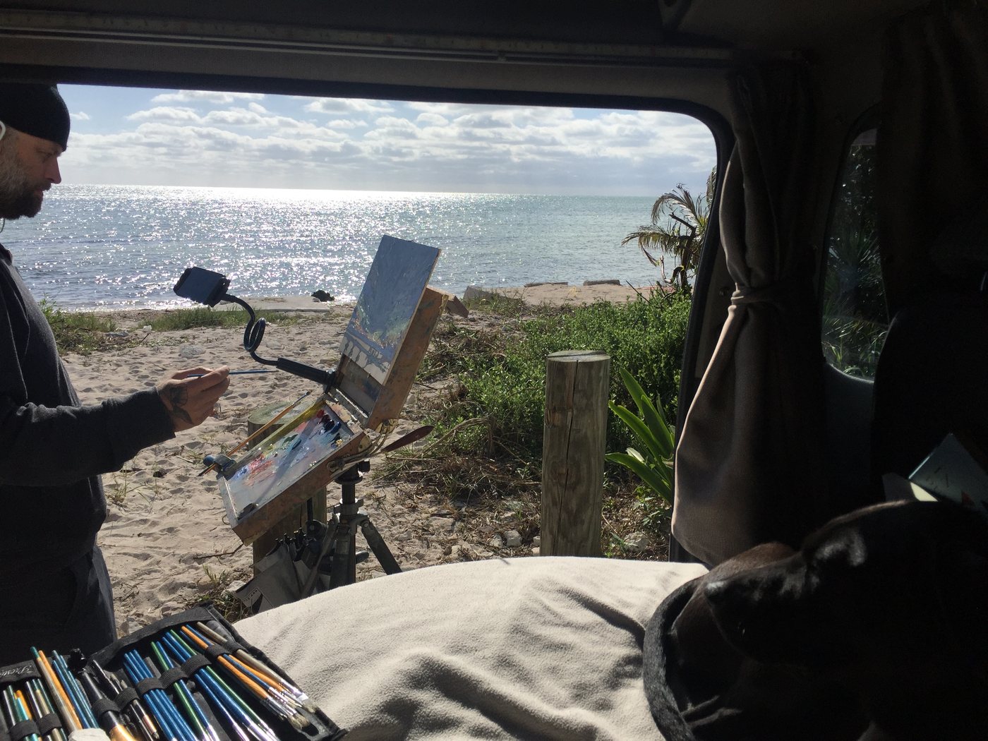 Mark painting from inside the van, the sea through the side door
