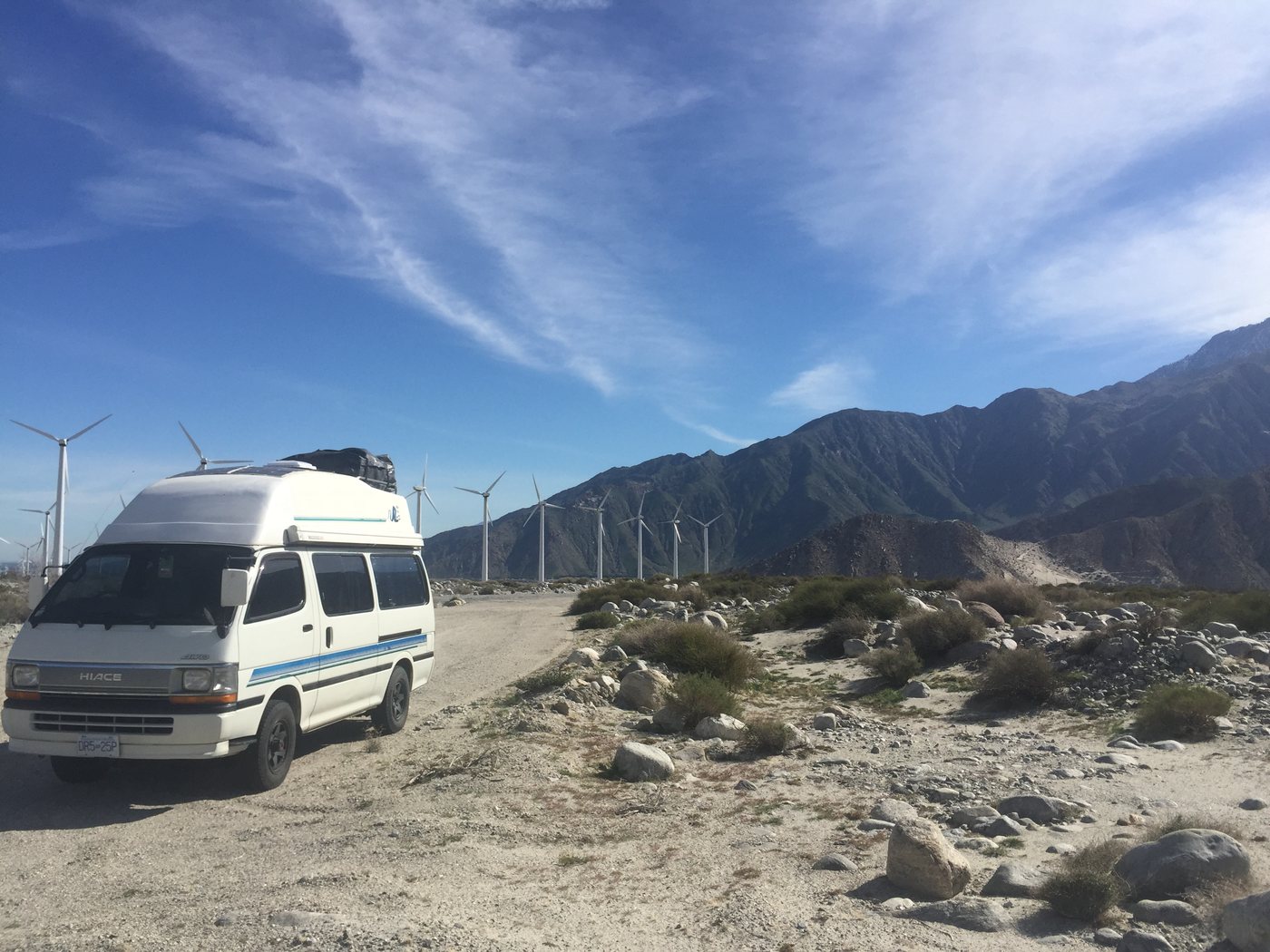 The van below the mountains and wind turbines near Palm Springs