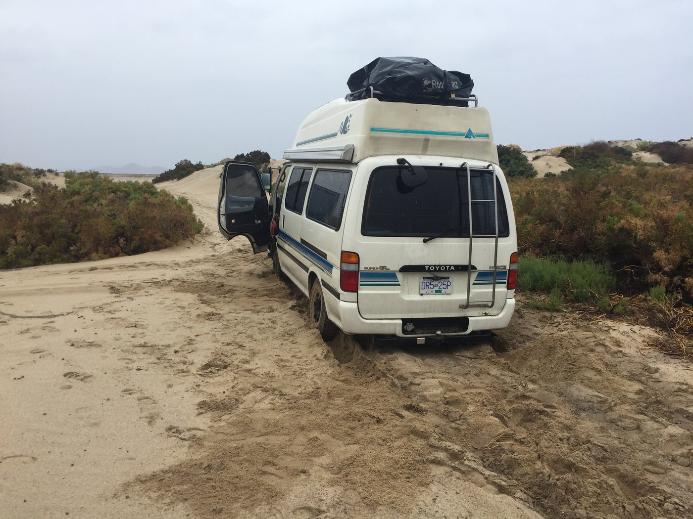 The van on a sandy track through the dunes